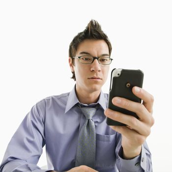 Asian businessman with serious expression looking at his pda cellphone.