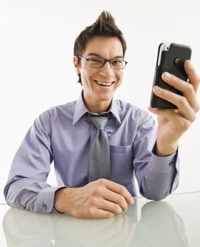 Smiling Asian businessman with his pda cellphone.