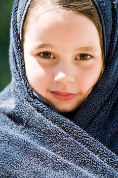 Young child enjoying the sun in and around the swimming pool