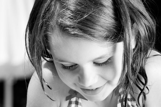 Young child enjoying the sun in and around the swimming pool