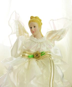 a doll with white dress isolated in white
