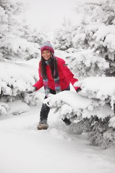 winter woman play snowballs on snow background