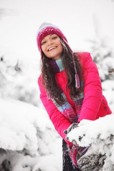 winter woman play snowballs on snow background