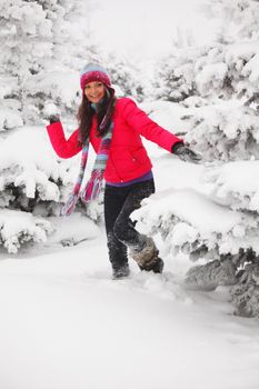 winter woman play snowballs on snow background