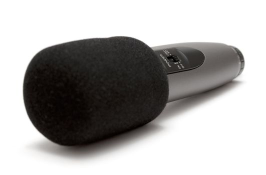 Black microphone isolated on a white background.