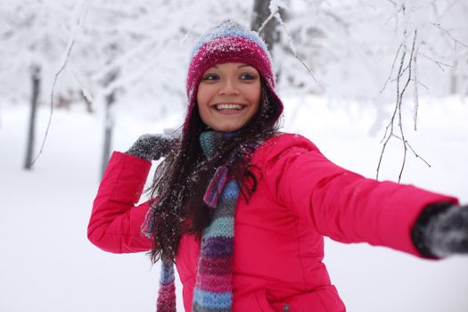 winter woman play snowballs on snow background