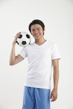 young man holding a football