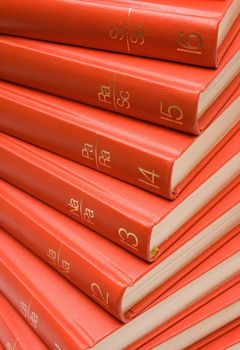 Stack of red textbooks.