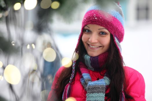 woman in winter hat and holyday bokeh