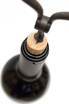 Opening a bottle of wine. Isolated on a white background.