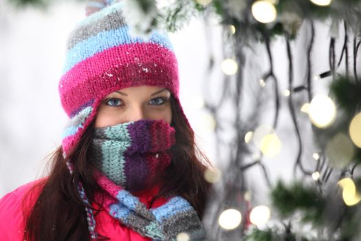 woman in winter hat and holyday bokeh