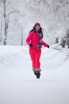 woman run in winter park very happy