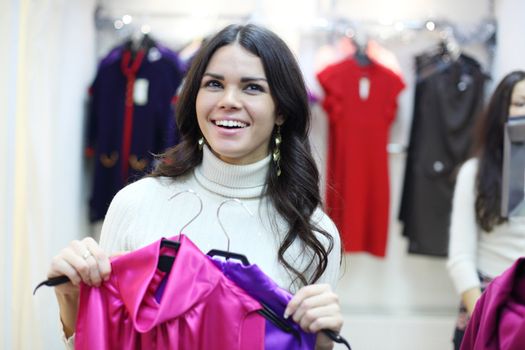 woman in shop look at clothes