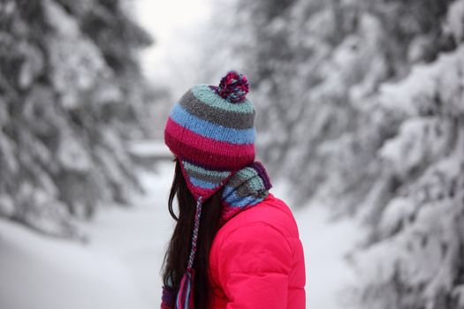 woman in winter park snow on background