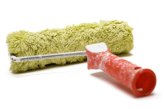 Used paint roller isolated on a white background.