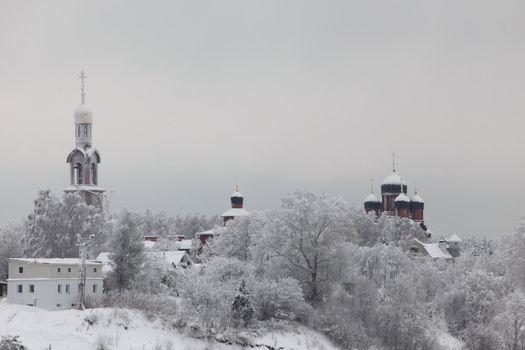 houses in winter forest snow around