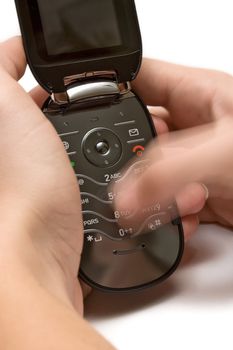 Woman sending a text message on an old-fashioned cell phone.