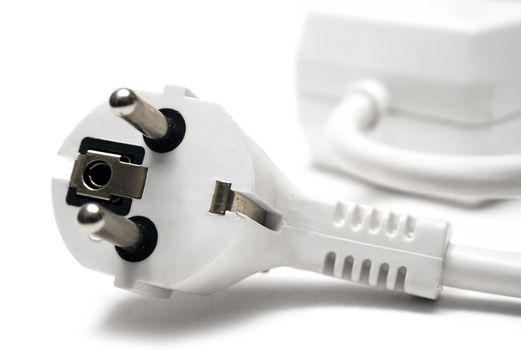 White extension cable and plug isolated on a white background.