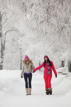 two winter women run by snow frosted alley