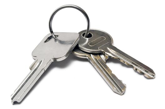 Three apartment keys on a metal ring isolated on a white background.
