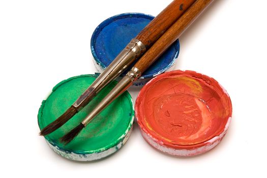 Watercolor pots and two paintbrushes isolated on a white background.