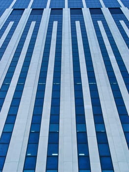 Modern office skyscraper full of glass and blue reflection