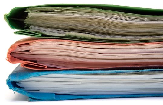 Stacked colored binders isolated on a white background.