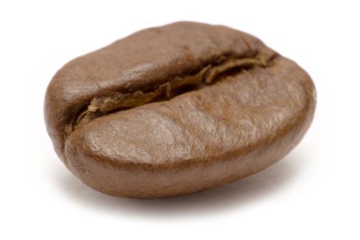 Macro shot of a single coffee bean isolated on a white background.