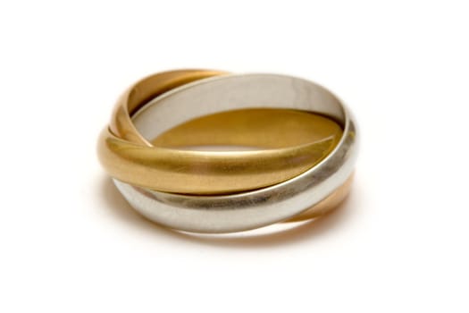 Linked silver, gold and bronze ring isolated on a white background.