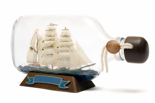 Old sailing ship model in a bottle. Isolated on a white background.