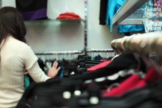 woman in shop look at clothes