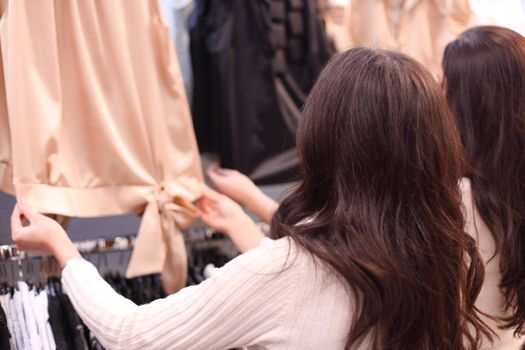 woman in shop look at clothes