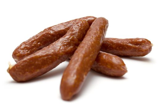 Heap of smoked sausages isolated on a white background..