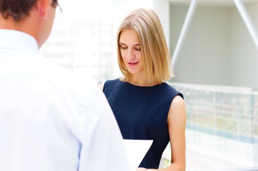 male and female entrepreneurs working together, discuss reports