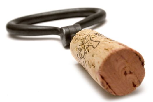 Brown cork and vintage corkscrew isolated on a white background.