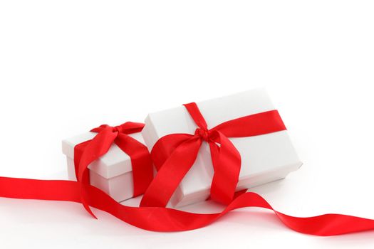 white gift with red ribbon