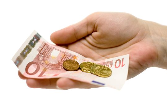 Woman holding Euro banknotes and coins in her hand. Isolated on a white background.