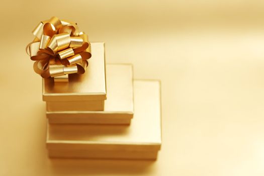 golden christmas gifts on gold background 