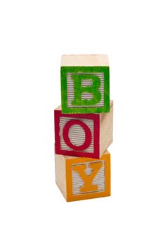 Wooden blocks stacked that spell out boy.  Isolated on white background.