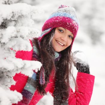 winter woman play snowballs on snow background