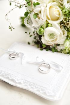 Two wedding rings on a white pad