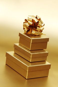 golden christmas gifts on gold background 