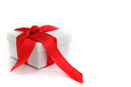 white christmas gift with red ribbon