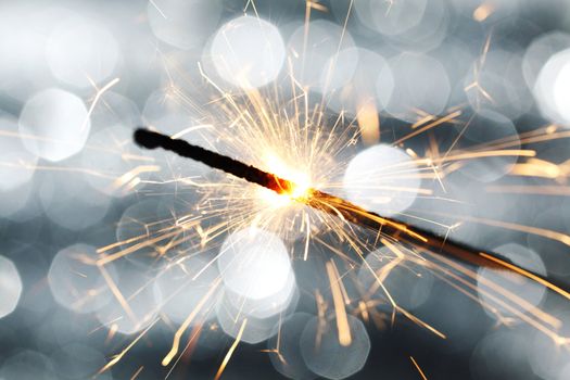 sparkler on silver bokeh background macro close up