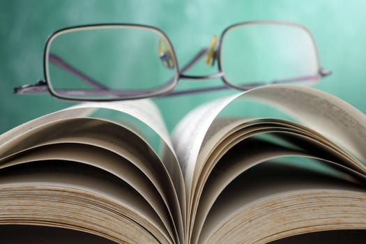 spectacles on an opened book