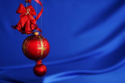 red christmas balls on blue satin background
