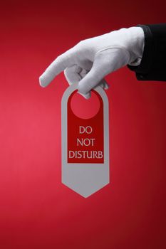  close up of the hotel staff holding a door sign do not disturb