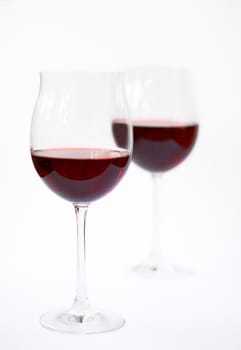 Two glasses of red wine isolated on a white background.