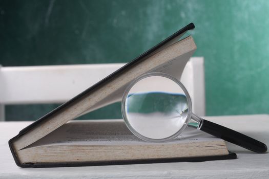 magnifier resting on the open page book