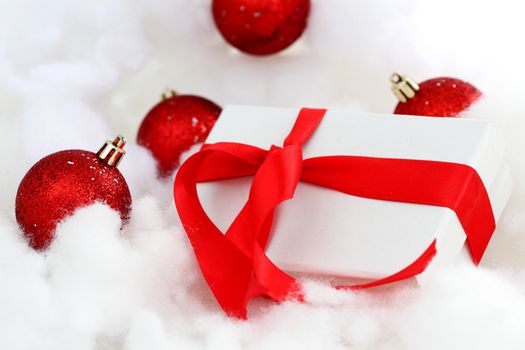  white christmas gift with red heart ribbon